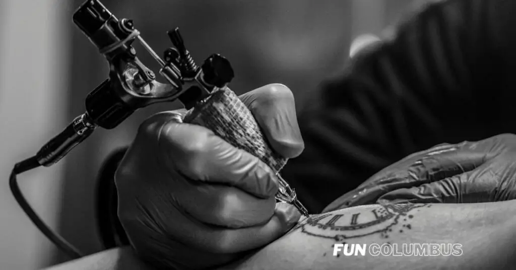 The Best Tattoo Shops in Columbus: A tattoo artist giving a customer a tattoo