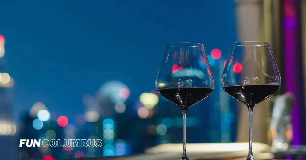 Best Rooftop Bars in Columbus - Two wineglasses and a city view.